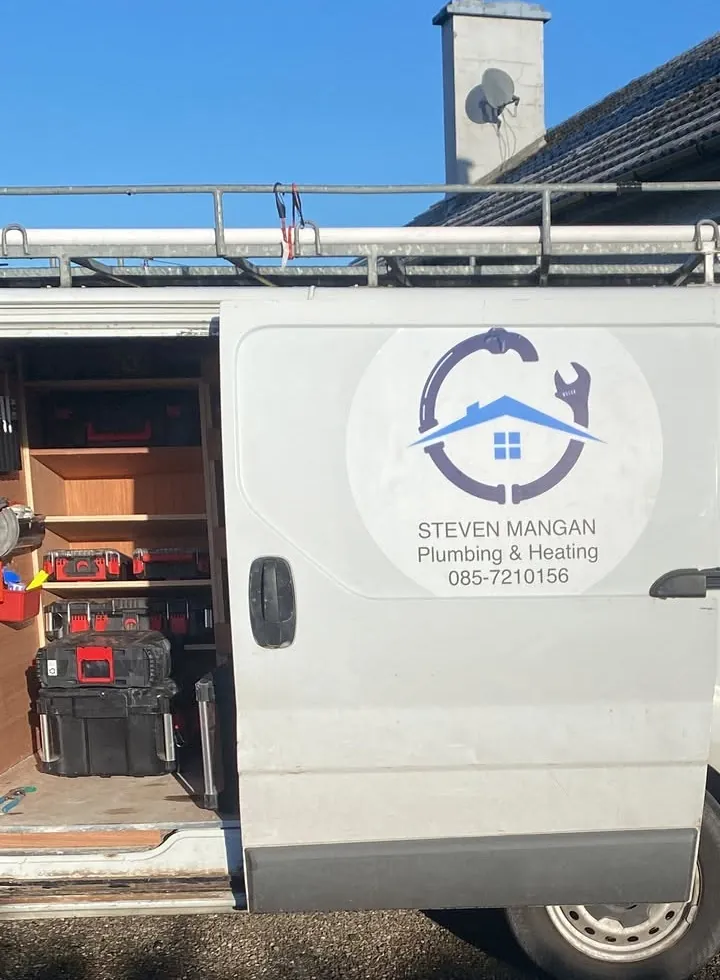 A Steven Mangan Plumbing & Heating van with its side door open on shelving and tool cases